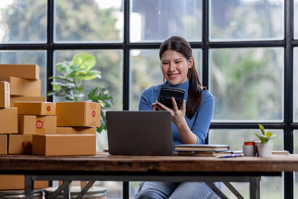 Woman on phone and laptop